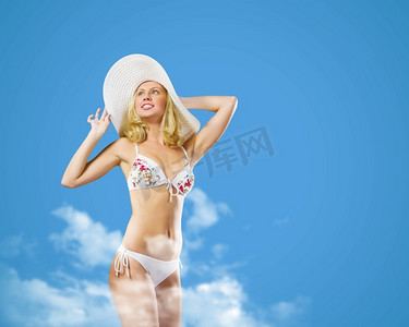 暑假。在彩色背景下，穿着泳衣戴着帽子的漂亮女孩