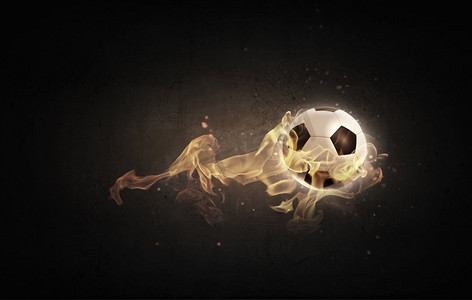 火焰足球摄影照片_热球。火光中的足球概念形象