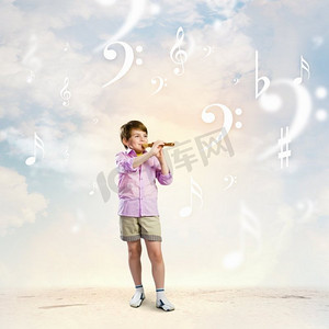 风吹儿童摄影照片_吹长笛的男孩。小可爱的男孩打长笛反对多云的背景图像