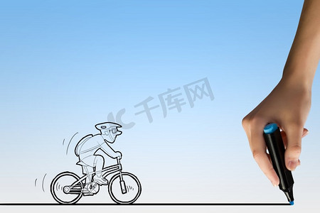 手绘自行车摄影照片_画着脸的自行车车手。骑自行车的人漫画和人的手绘线条