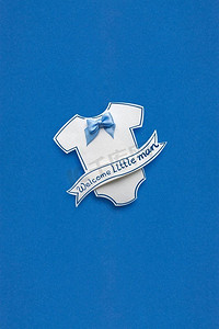 蓝色背景用纸制作的儿童套头衫的创意概念照片。