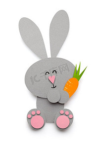 创意复活节概念照片，一只兔子在白色背景下用纸做的胡萝卜。