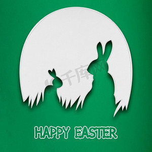 复活节照片摄影照片_创意复活节概念照片，两只兔子在绿色背景下用纸做的鸡蛋里。