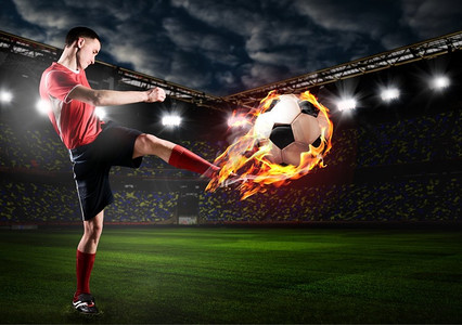 火焰足球摄影照片_球员在踢球。足球或足球运动员在体育场踢球