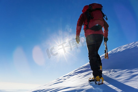 极限冬季运动：登山者在阿尔卑斯山积雪的山顶上。理念：决心、成功、勇敢。