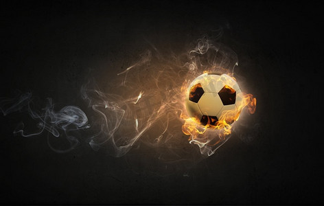 火焰足球摄影照片_热球。火光中的足球概念形象