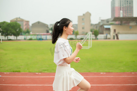 女孩跑道摄影照片_运动美女少女女孩人像跑道操场初中高中跑步学生
