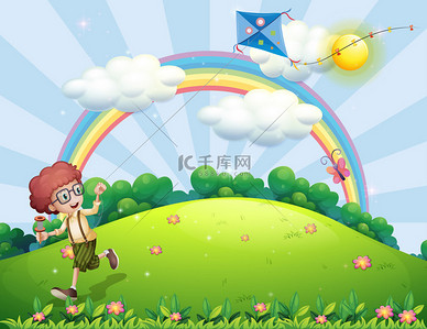 玩耍的男孩背景图片_男孩玩耍着他的风筝在山顶上，一条彩虹