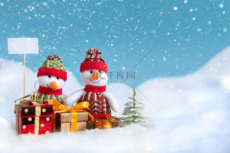 雪人在雪地里带着圣诞礼物和新年礼物