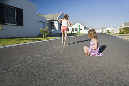 南非开普敦两个女孩在街上玩跳房子