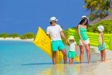 在热带海滩度假的幸福美丽家庭