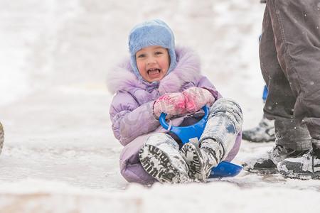 冬天小朋友摄影照片_五岁女孩滚下冰滑梯差点撞到其他小朋友