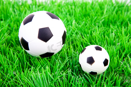 塑料草地上一大一小足球