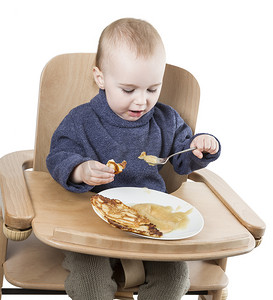 在高脚椅上吃饭的幼儿