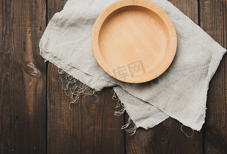 器皿摄影照片_桌上空的圆形棕色木板