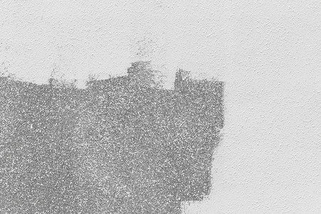 墙面艺术油漆摄影照片_建筑立面上的白色油漆刷笔触，灰色抽象图案墙面纹理外部背景