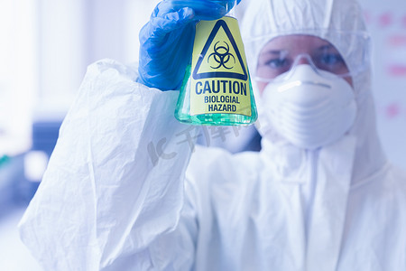 烧瓶中有危险化学品的防护服科学家