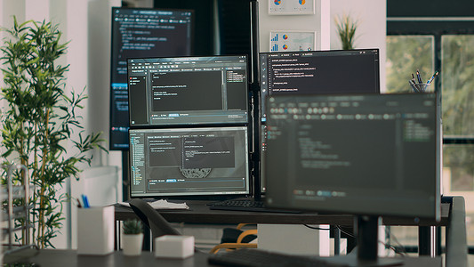 空数据室办公桌上的电脑屏幕显示程序代码和