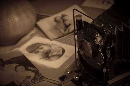 相册背景摄影照片_桌子上的旧相册旁边放着一台照相机。