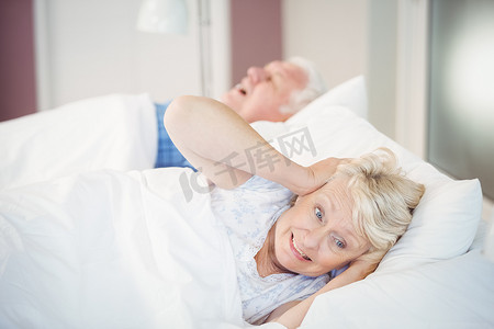 男人在床上打呼噜时，高级女人捂着耳朵