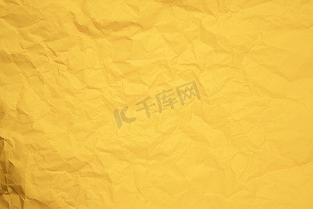 黑色纹理纸张摄影照片_从弄皱的黄色纸张纹理的抽象背景。