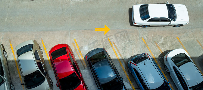停在带黄色 l 的混凝土停车场的汽车的顶部视图