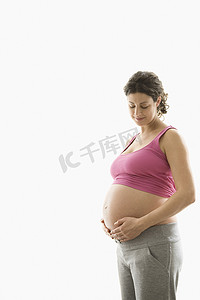 白色背景下闭着眼睛站着的漂亮年轻孕妇