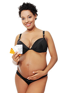 孕妇生病摄影照片_穿着黑色内衣的孕妇。