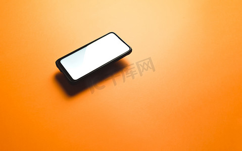 简约的模拟平面图像设计，带有带有复制空间和白色屏幕的浮动手机，可在平面橙色背景上书写