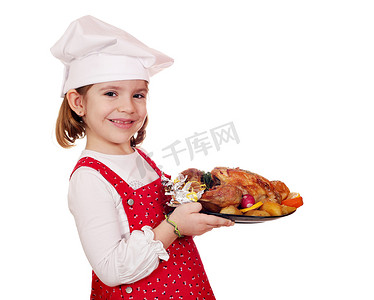 女孩吃鸡摄影照片_快乐的小女孩厨师拿着烤鸡