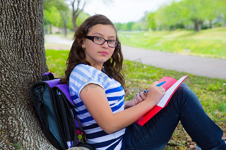 公园树下背着书包的聪明学生少女