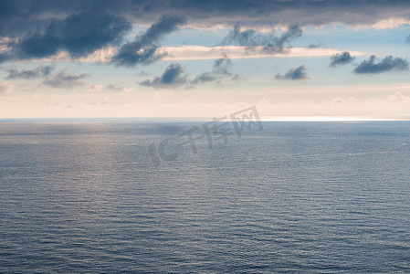 天气阴沉摄影照片_海、地平线和阴沉的天空简洁的水光滑的表面