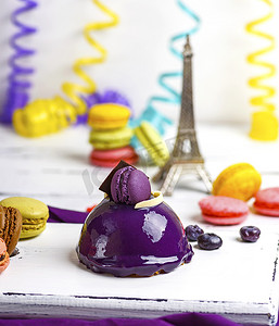 马卡龙背景板摄影照片_淡紫色圆形蛋糕配马卡龙