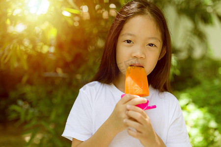 亚洲儿童在炎热的夏日吃冰棒冰淇淋
