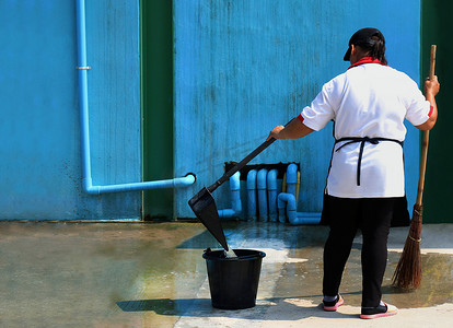 人们在地面街道扫脏水，清洁地板，女仆，管家，家庭主妇，女仆，女仆