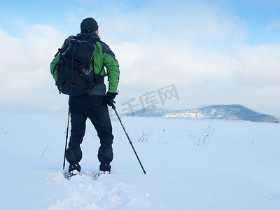 穿雪鞋的人在雪地里休息。