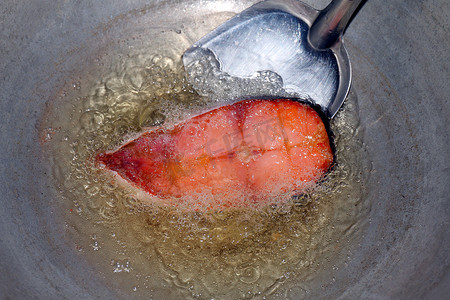 炸油摄影照片_热油锅炸鱼片、饮食用炸鱼、油锅炸鱼片是食物蛋白饮食健康