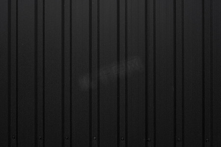 墙壁的黑波纹状的金属板纹理表面。
