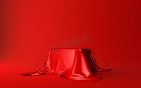 红色背景上隔离的红色丝绸布覆盖的现实盒子