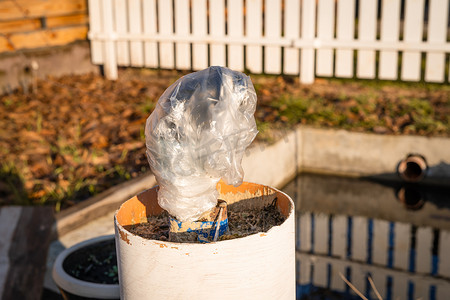 水龙头接水摄影照片_用塑料袋包裹的花园水龙头在冬天前与供水系统断开连接