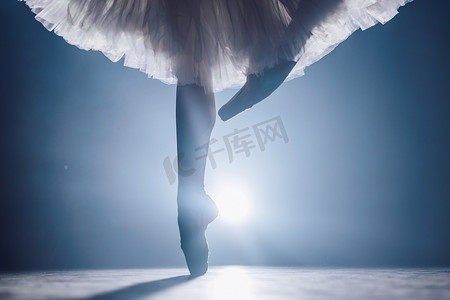 芭蕾舞演员在黑暗的舞台或工作室练习时的特写。