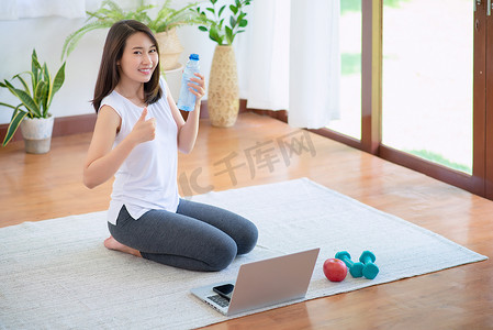 美丽的亚洲女性通过在家锻炼健康潮流生活方式来保持健康