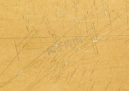 高度详细的棕色纸板纹理，有许多刀切痕迹和磨损的划痕，使用具有撕裂表面的垃圾细粒分层纸板，用于壁纸设计