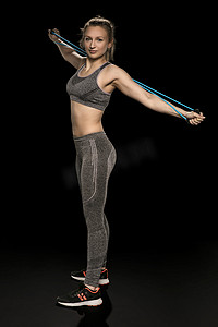 运动女孩用柔韧的绳子伸展和锻炼