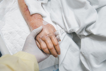 心理治愈摄影照片_病人在医院里握着一只手