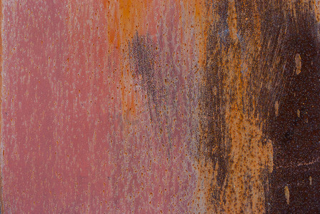 橙色创意背景摄影照片_生锈金属的创意背景，不小心涂上橙色和粉色油漆，垃圾金属表面，适合您的项目的出色背景或纹理