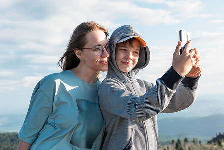 一个孩子和妈妈在智能手机上自拍