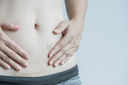 阑尾炎摄影照片_女人腹部因剖腹产而出现深色疤痕的特写