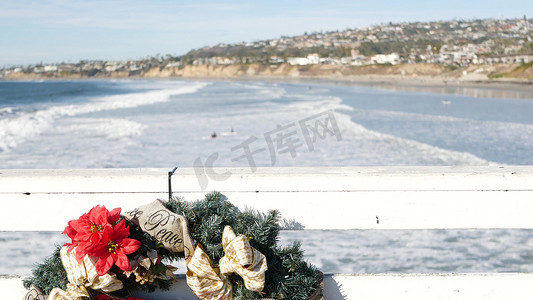 美国新年摄影照片_在码头的圣诞花环，在海洋海岸的新年，在圣诞节的加利福尼亚海滩。