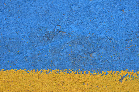 蓝色和黄色被绘的混凝土墙纹理
